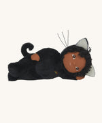 Olli Ella Carson Cat Dinky Dinkum Doll laying on it's side. This soft toy is a black cat with glow in the dark inner ears and a small embroidered rainbow detail on the chest. These soft toys are part of Olli Ella's Halloween collection available here at Babipur.