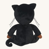 The back of an Olli Ella Carson Cat Dinky Dinkum Doll. This soft toy is a black cat with glow in the dark inner ears and a small embroidered rainbow detail on the chest. These soft toys are part of Olli Ella's Halloween collection available here at Babipur.