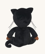 The back of an Olli Ella Carson Cat Dinky Dinkum Doll. This soft toy is a black cat with glow in the dark inner ears and a small embroidered rainbow detail on the chest. These soft toys are part of Olli Ella's Halloween collection available here at Babipur.