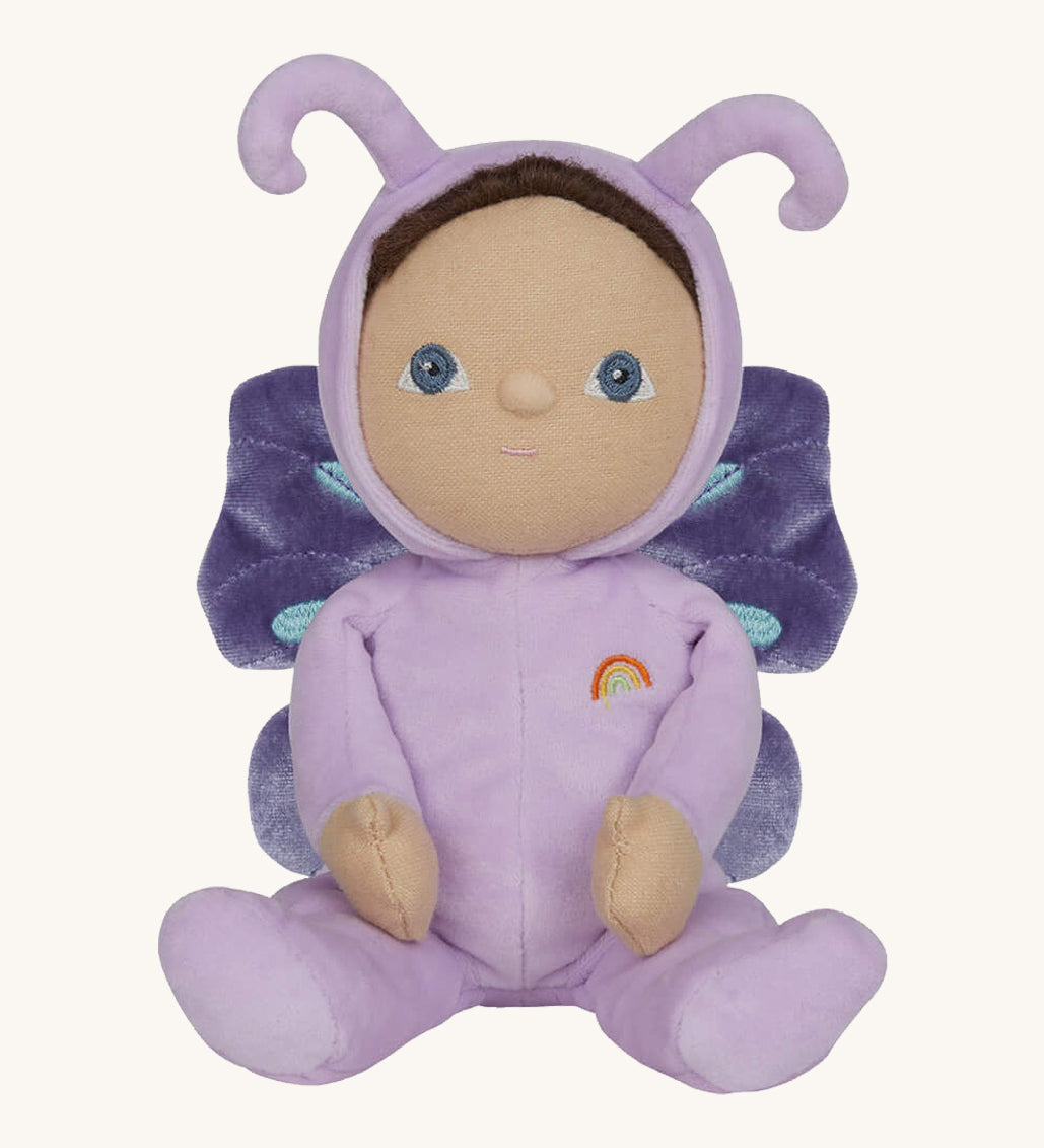 The Olli Ella Dinky Dinkum Doll - Betty Butterfly - in a light purple onesie, with brown hair, blue eyes, dark purple butterfly wings, and antennae.