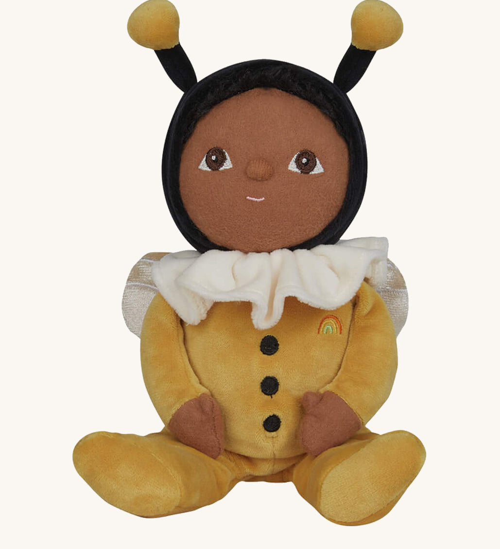 The Olli Ella Dinky Dinkum Doll - Billie Bumblebee - in a yellow onesie with a black hood and antennae, with a white ruffled collar, brown eyes, and buzzy bee wings.