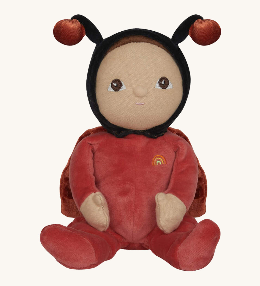 The Olli Ella Dinky Dinkum Doll - Lola Ladybug - in a red onesie with a black hood, brown hair and eyes, spotty ladybird wings, and antennae.