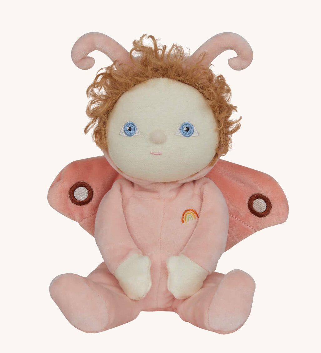 The Olli Ella Dinky Dinkum Doll - Millie Moth - with a peach coloured onesie, moth wings, curly ginger hair, and antennae.