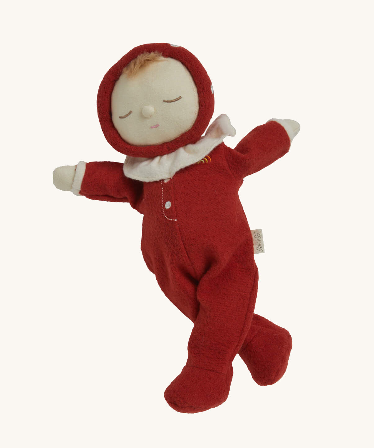 The Olli Ella Dozy Dinkum Doll - Toadstool Moppet, wearing a red mushroom onesie with a white ruffled collar.