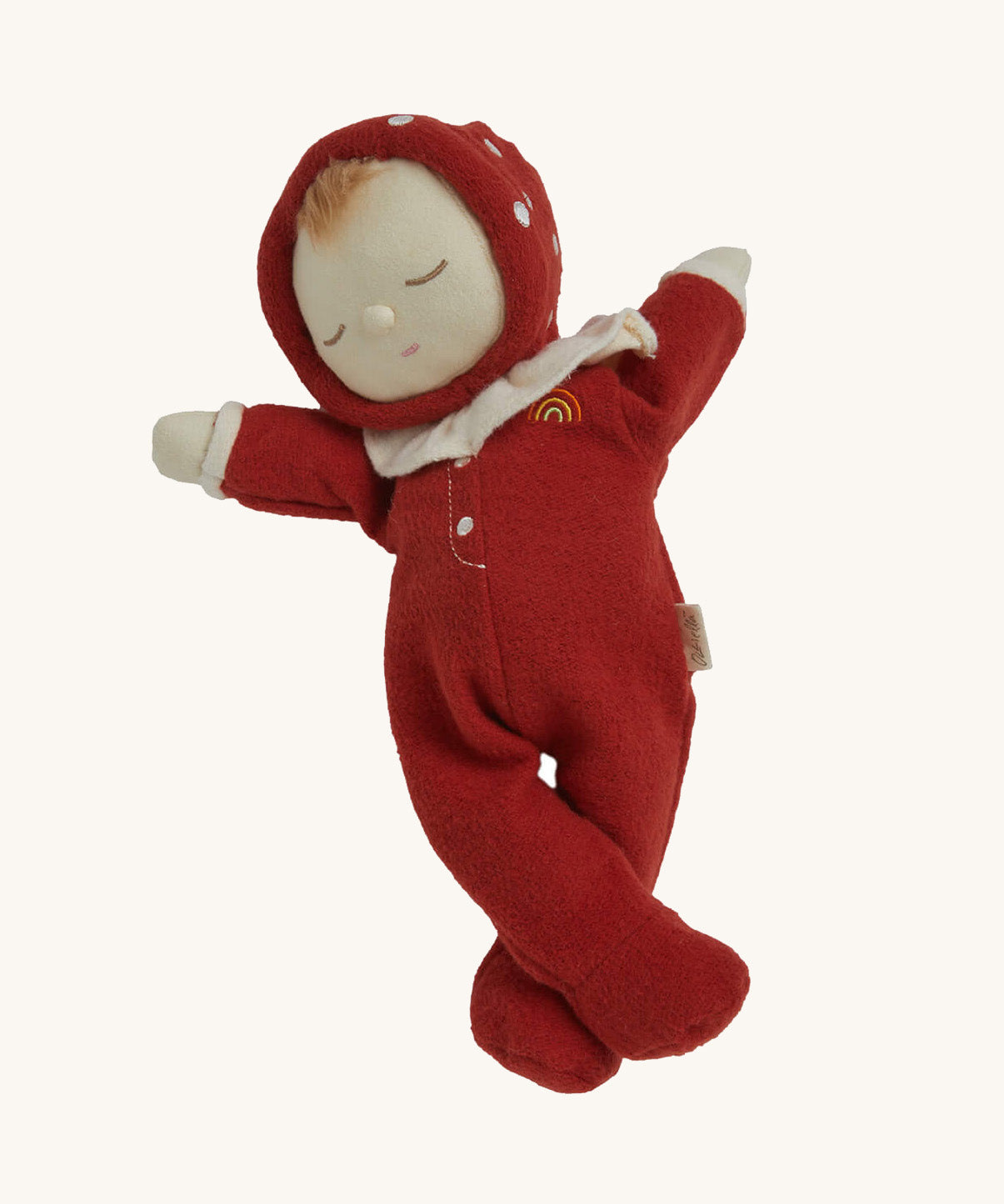The Olli Ella Dozy Dinkum Doll - Toadstool Moppet, wearing a red mushroom onesie with a white ruffled collar.