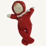 The Olli Ella Dozy Dinkum Doll - Toadstool Moppet, wearing a red mushroom onesie with a white ruffled collar.