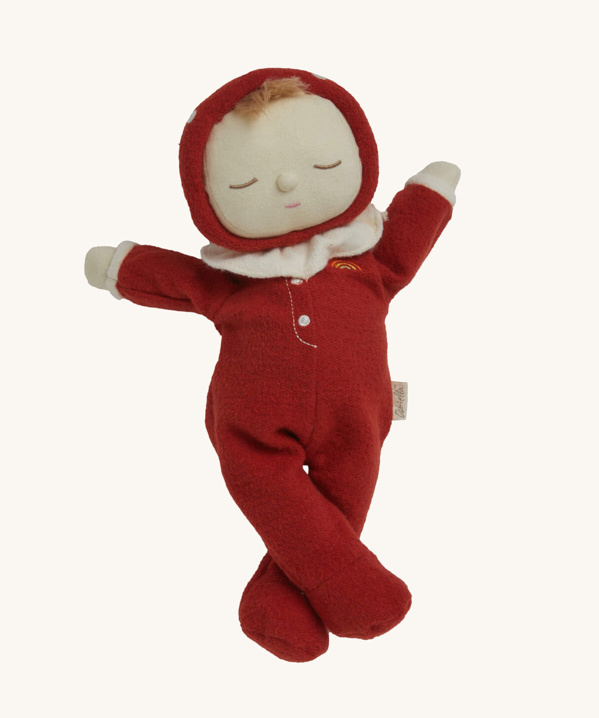 The Olli Ella Dozy Dinkum Doll - Toadstool Moppet, wearing a red mushroom onesie with a white ruffled collar.