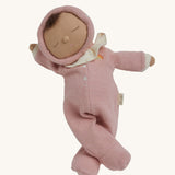 The Olli Ella Dozy Dinkum Doll - Toadstool Pip. It has a pink onesie with a and a ruffled collar.