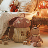 The Olli Ella Dozy Dinkum Doll - Toadstool Pip. It is in a bedroom with a mushroom rattan doll's house basket.