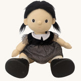 An Olli Ella Wendy Witch dream Dinkum doll in a seated position shown without her hat. A dinkum doll with a black dress, witches hat, black shoes and a magnetic broom accessory. This doll is part of Olli Ella's Halloween collection available here at Babipur.