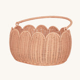 Olli Ella Petal Basket in Seashell Pink with the handle shown down.