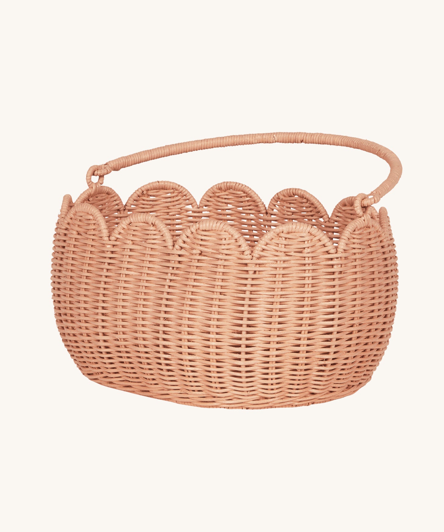 Olli Ella Petal Basket in Seashell Pink with the handle shown down.
