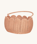 Olli Ella Petal Basket in Seashell Pink with the handle shown down.