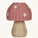 The Olli Ella rattan toadstool lamp with a natural base and a pink mushroom top