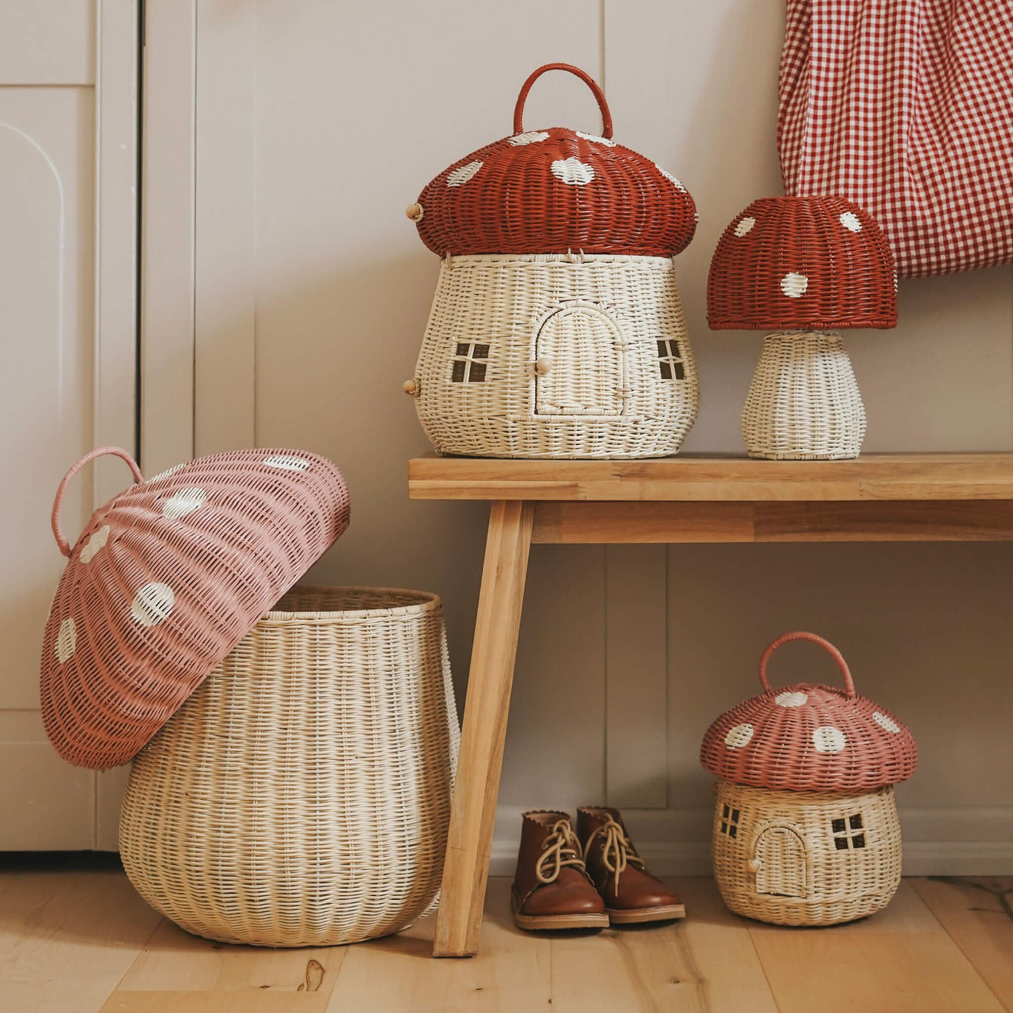 The Olli Ella large woven rattan storage baskets, in the shape of mushrooms with spotty pink and red toadstool lids.