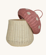 The Olli Ella large woven rattan storage basket, in the shape of a mushroom with a spotty pink toadstool lid.