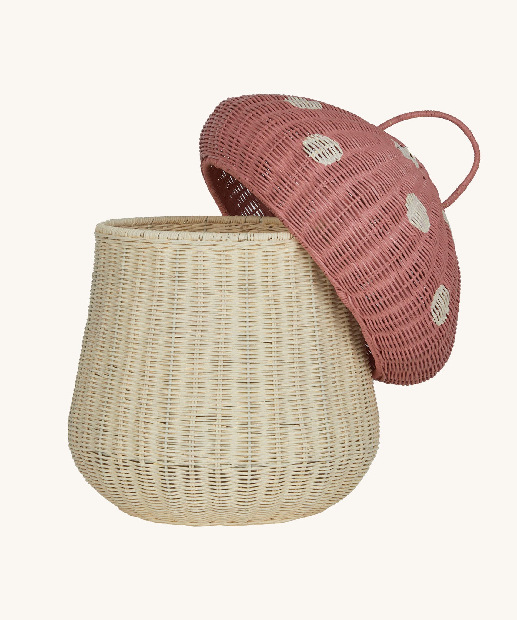 The Olli Ella large woven rattan storage basket, in the shape of a mushroom with a spotty pink toadstool lid.