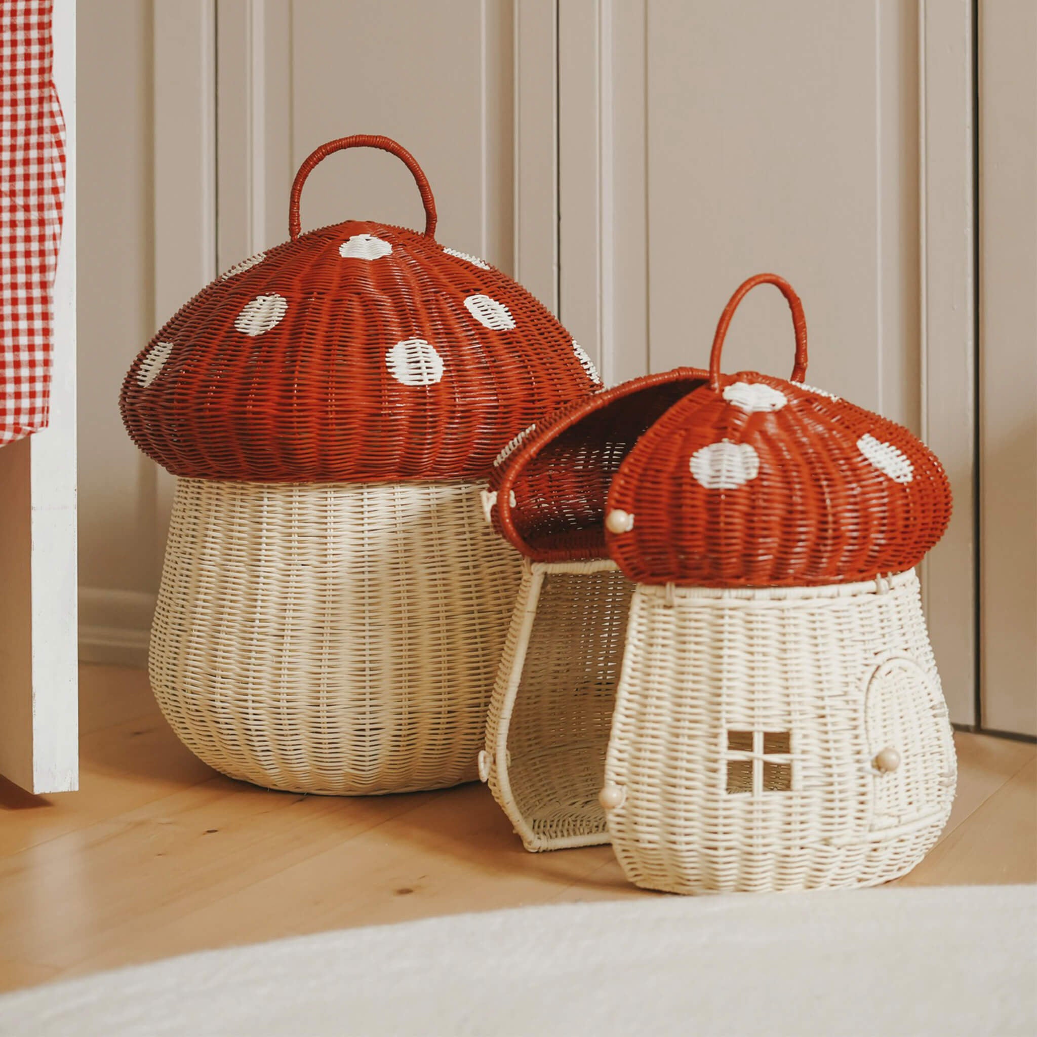 The Olli Ella large and small woven rattan storage baskets, in the shape of mushrooms with spotty red toadstool lids.