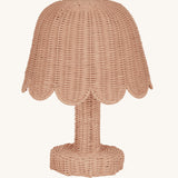 An Olli Ella Rattan Petal Lamp in the seashell pink colourway.
