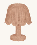 An Olli Ella Rattan Petal Lamp in the seashell pink colourway.