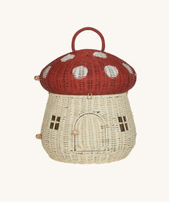 The Olli Ella Rattan Woven mushroom doll's house, with a red spotty toadstool top and an opening door.