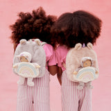 2 kids with the lilac and pink olli ella fluffy backpacks on their backs with the dinky dinkum dolls sitting inside