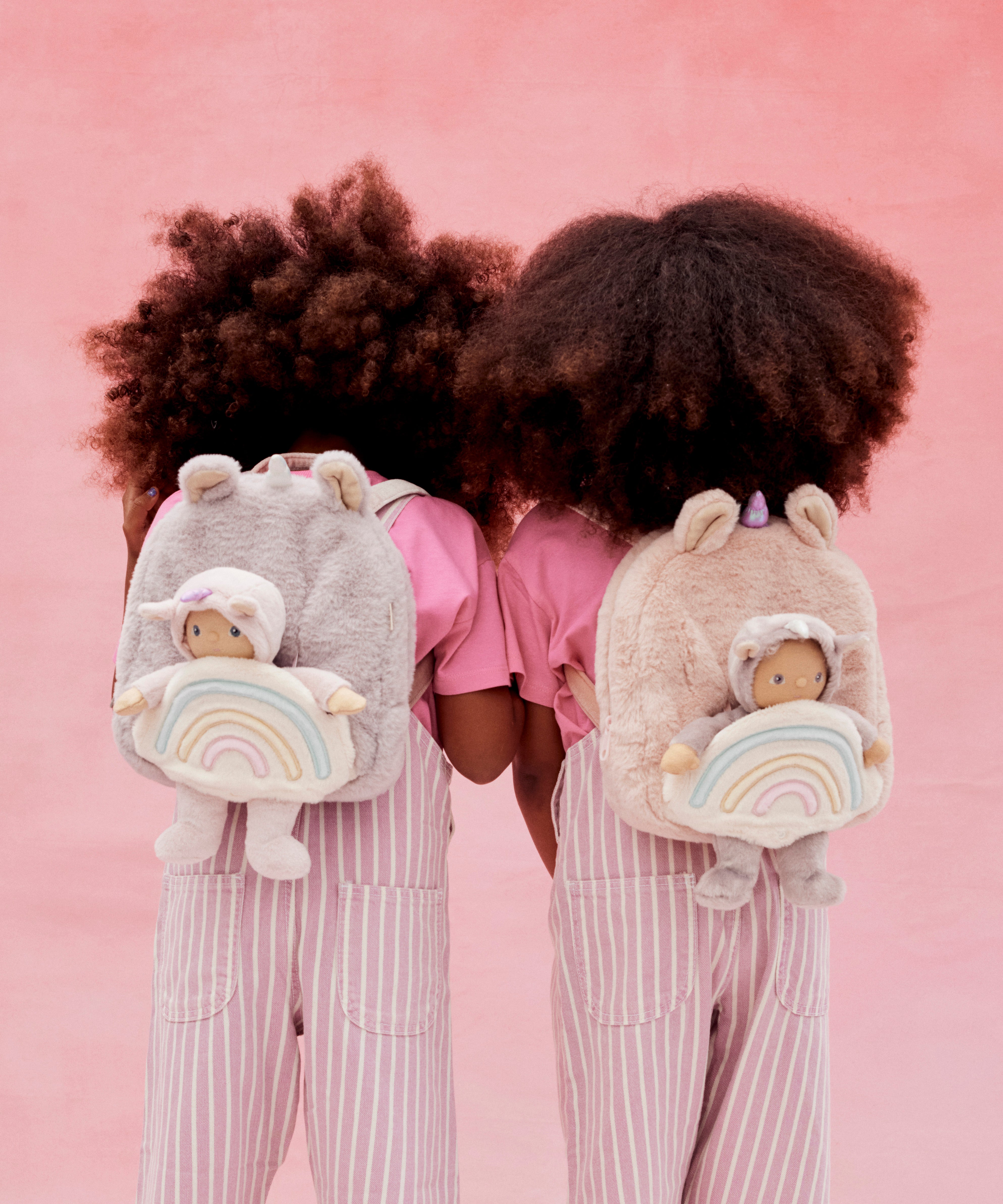 2 kids with the lilac and pink olli ella fluffy backpacks on their backs with the dinky dinkum dolls sitting inside