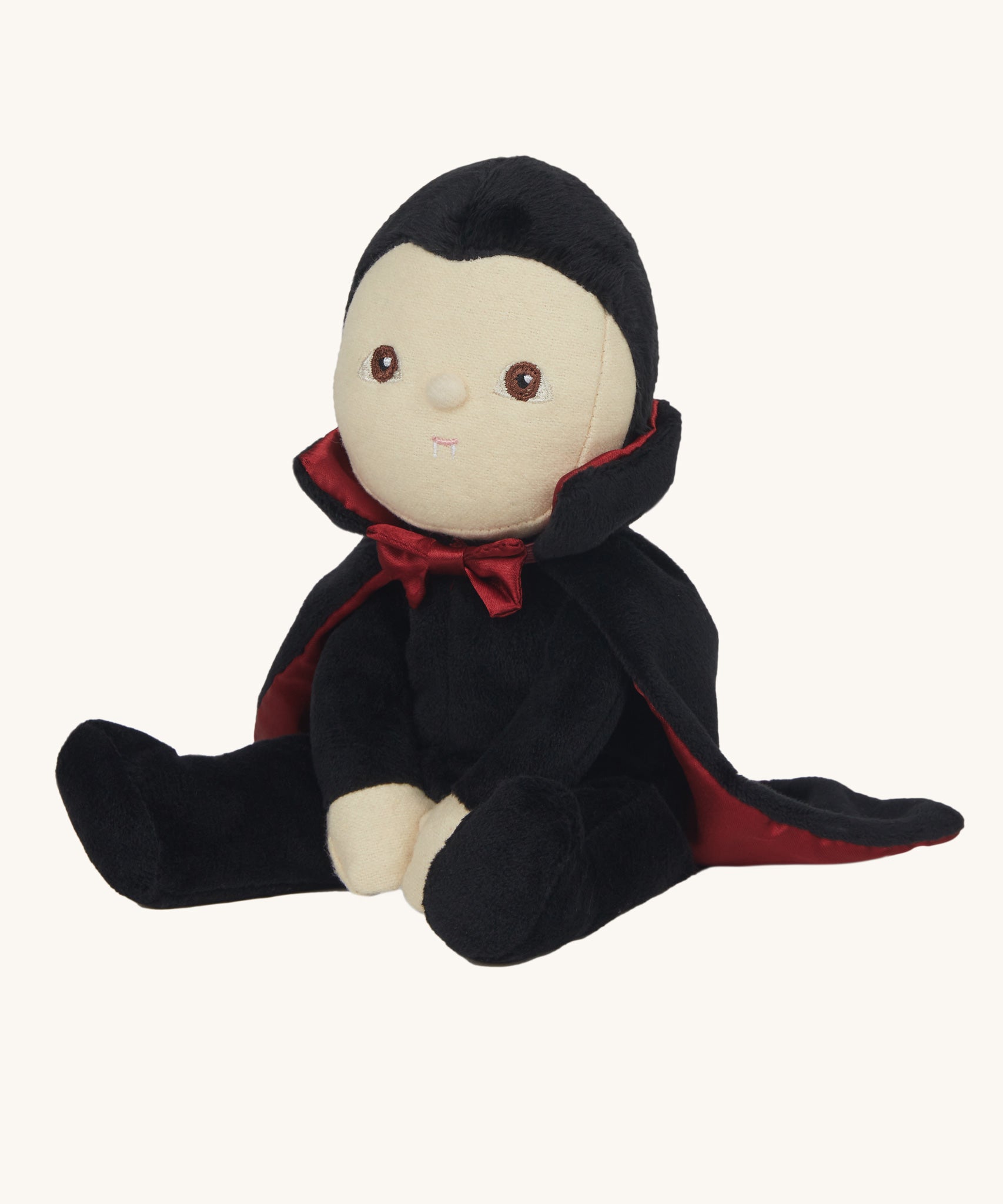 Olli Ella Vincent Vampire Dinky Dinkum doll. A soft vampire doll with a black cape with bat shaped glow in the dark details on the back. These soft toys are part of Olli Ella's Halloween collection available here at Babipur.