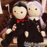 A child holding an Olli Ella Vincent Vampire Dinky Dinkum doll and a Willa Witch doll in their hand. Each doll has some glow in the dark features. These soft toys are part of Olli Ella's Halloween collection available here at Babipur.