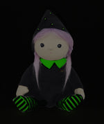 Olli Ella Willa Witch Dinky Dinkum Doll. A witch with a black outfit and matching hat with glow in the dark features on the striped tights, collar and stars on the hat. These soft toys are part of Olli Ella's Halloween collection available here at Babipur.