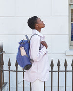 Two One Green Bottle 500ml Evolution Collection Bottle - Sports Cap bottles placed next to each other on a wooden picnic table. On the right is the One Green Bottle 500ml Evolution Collection Bottle - Sports Cap in Marshmallow