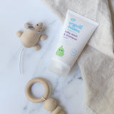 Organic Babies Baby Wash & Shampoo Lavender on a marble surface next to a wooden toy mouse and teething toy.