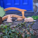 Three Ostheimer beavers shown in a small world play scene. One sitting, one laying down with a small beaver in the background. Check out our full range of expertly crafted wooden toy figures and scenery here at Babipur.