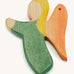 A green wooden angel figure on a cream background