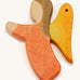 a orange wooden angel figure on a cream background