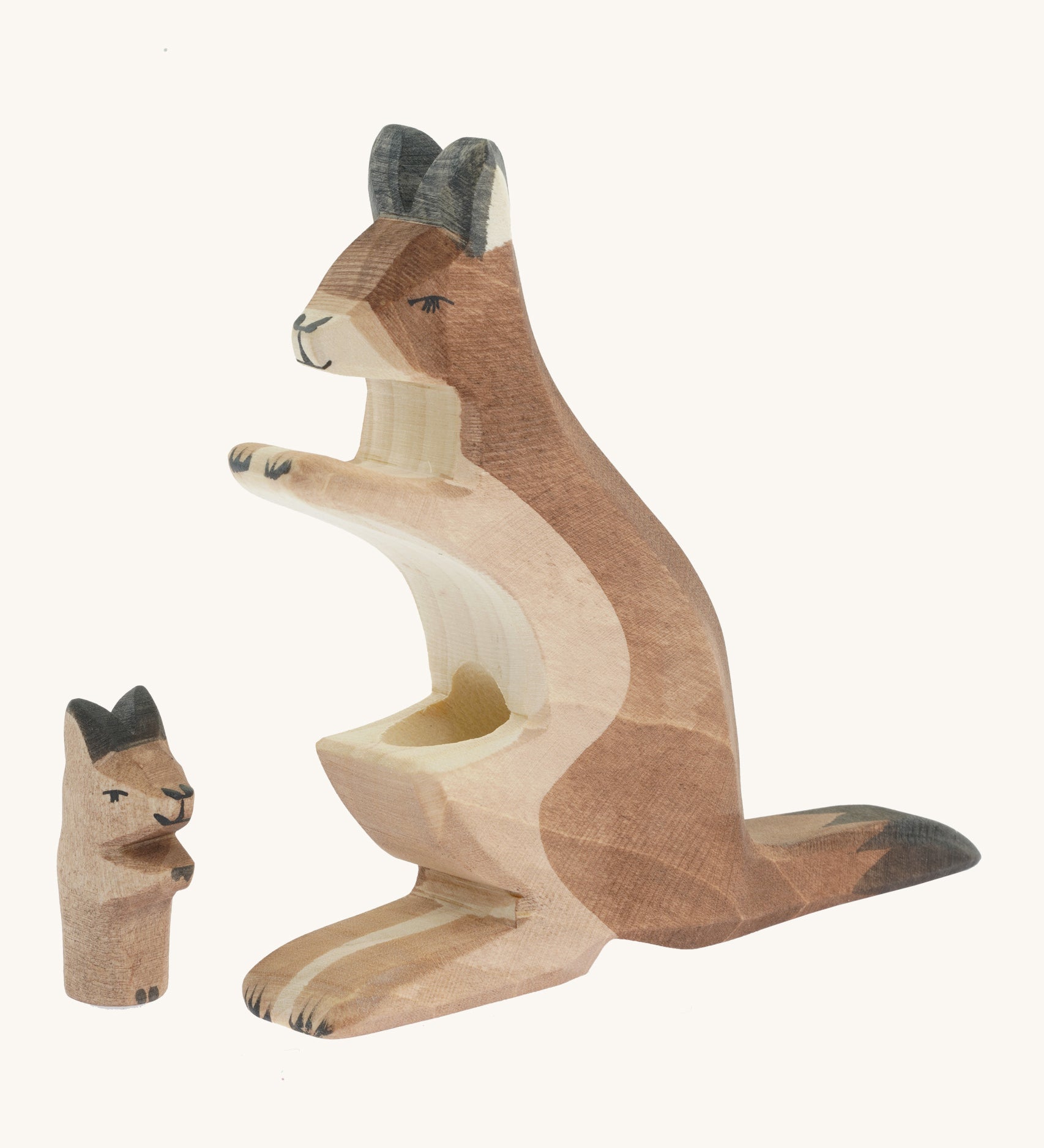 The Ostheimer wooden baby kangaroo figure next to the mother kangaroo figure showing the hole where the baby kangaroo sits