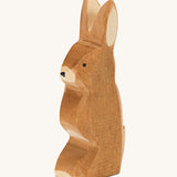 A wooden Ostheimer rabbit figure with ears pointing up on a cream background.