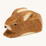 A small brown spotted Ostheimer rabbit figure on a cream background.