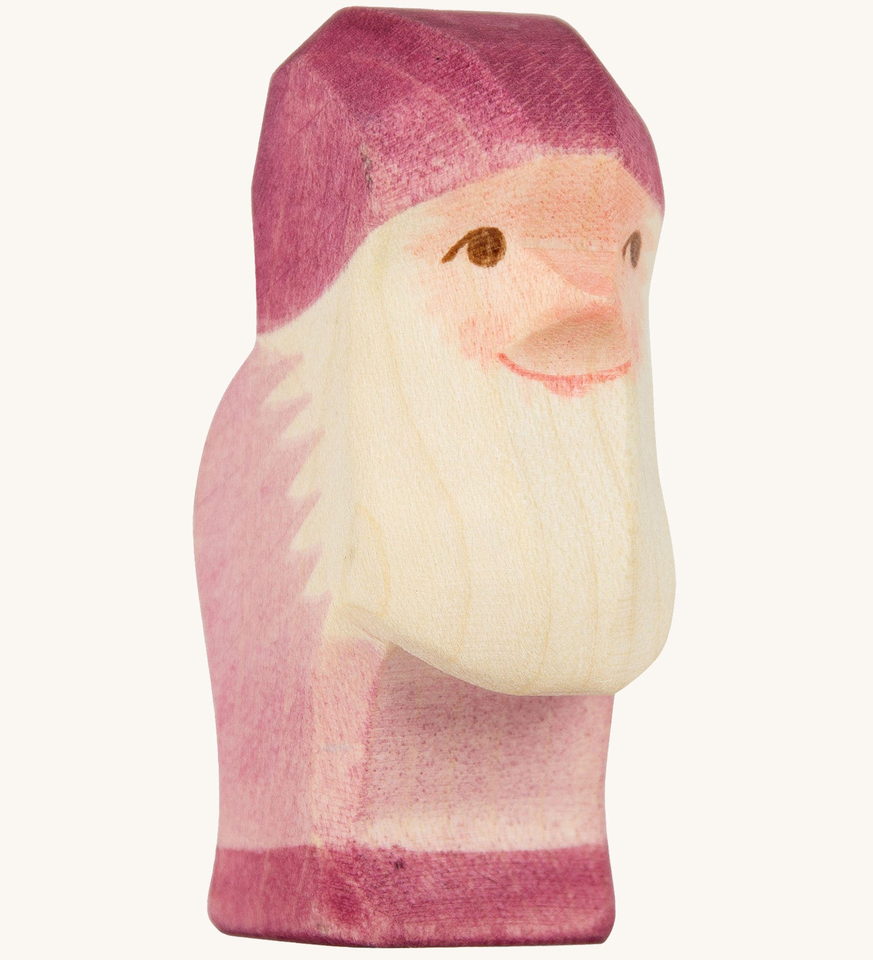 A violet wooden Ostheimer dwarf figure. The dwarf figure has a violet coloured outfit with matching hat and a white beard. This wooden figure is part of a large range of expertly hand crafted, Waldorf inspired, wooden toys here at Babipur.