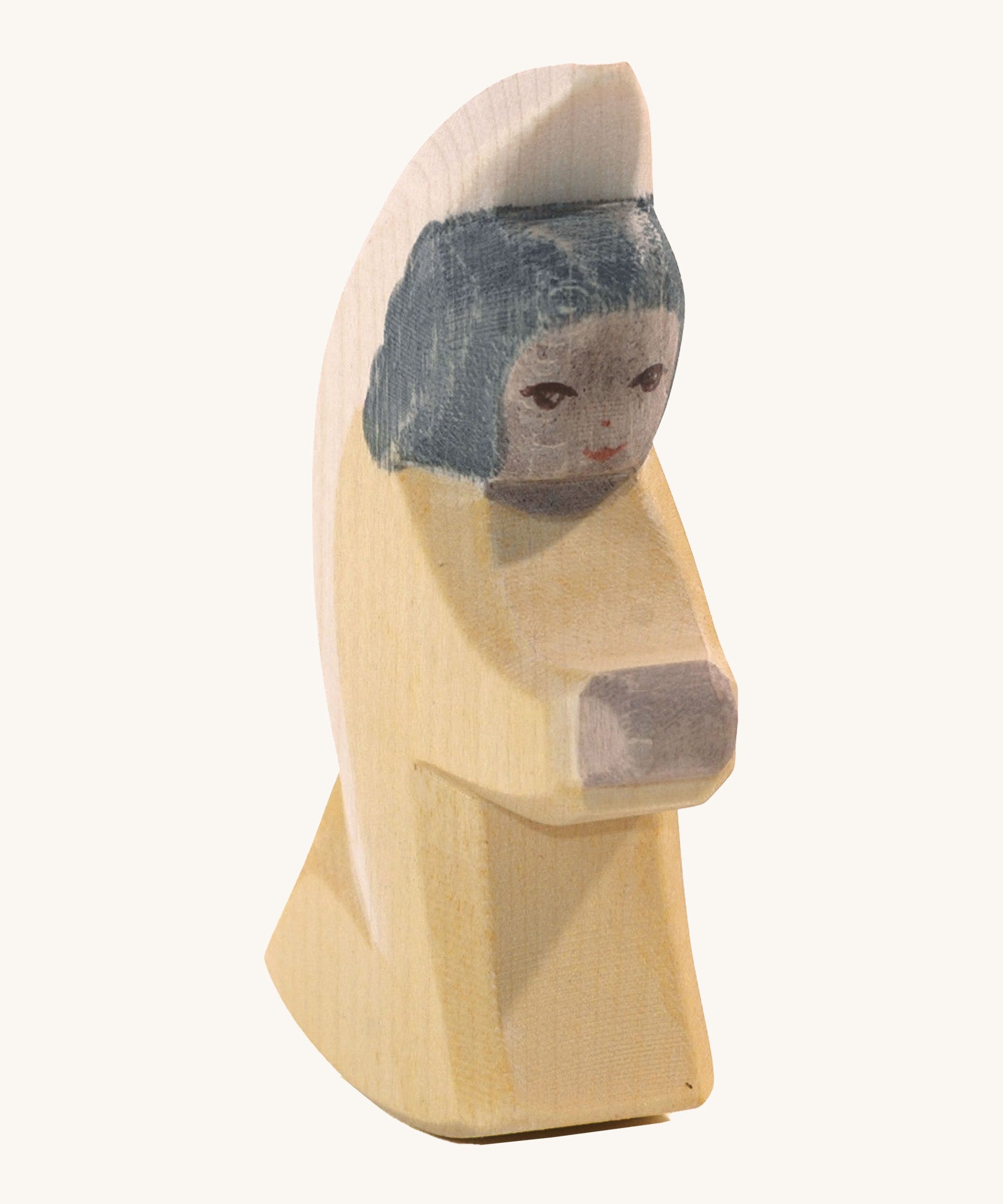 A yellow Ostheimer little angel wooden toy figure.