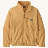 Patagonia synchilla fleece in a beeswax tan colour on a cream background.