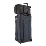 The Patagonia Black Hole Pack 32 litre capacity backpack in smolder slate-blue, on top of a black hole suitcase