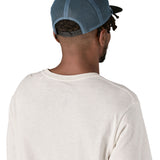 Patagonia airfarer cap in a birch white colour and Chouinard crest design worn by an adult back detail