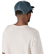 Patagonia airfarer cap in a birch white colour and Chouinard crest design worn by an adult back detail
