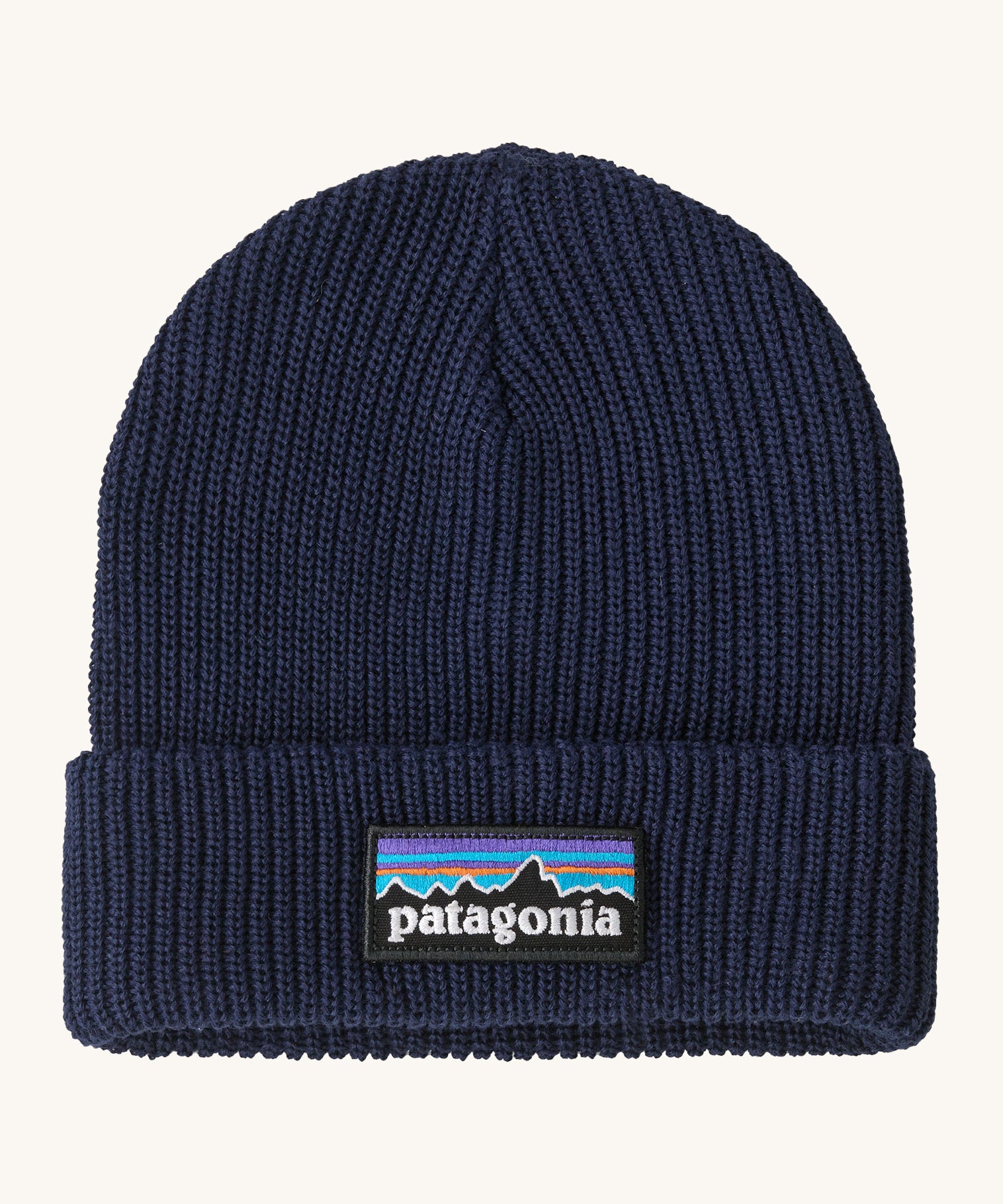 Patagonia kids beanie in new navy. A ribbed style beanie and features a turn up cuff with a brand patch stitched on top
