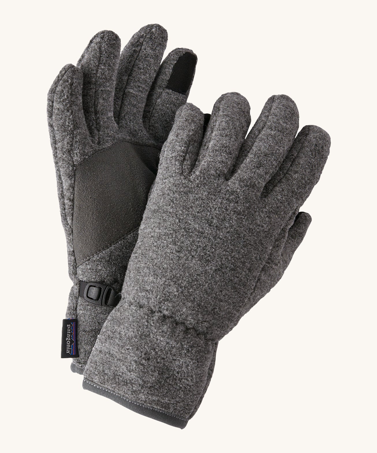 Close up of the Patagonia kids synchilla gloves clipped together for easy carrying features a grip panel on the palm, thumb and index finger.  Logo patch stitched on the wrist cuff.