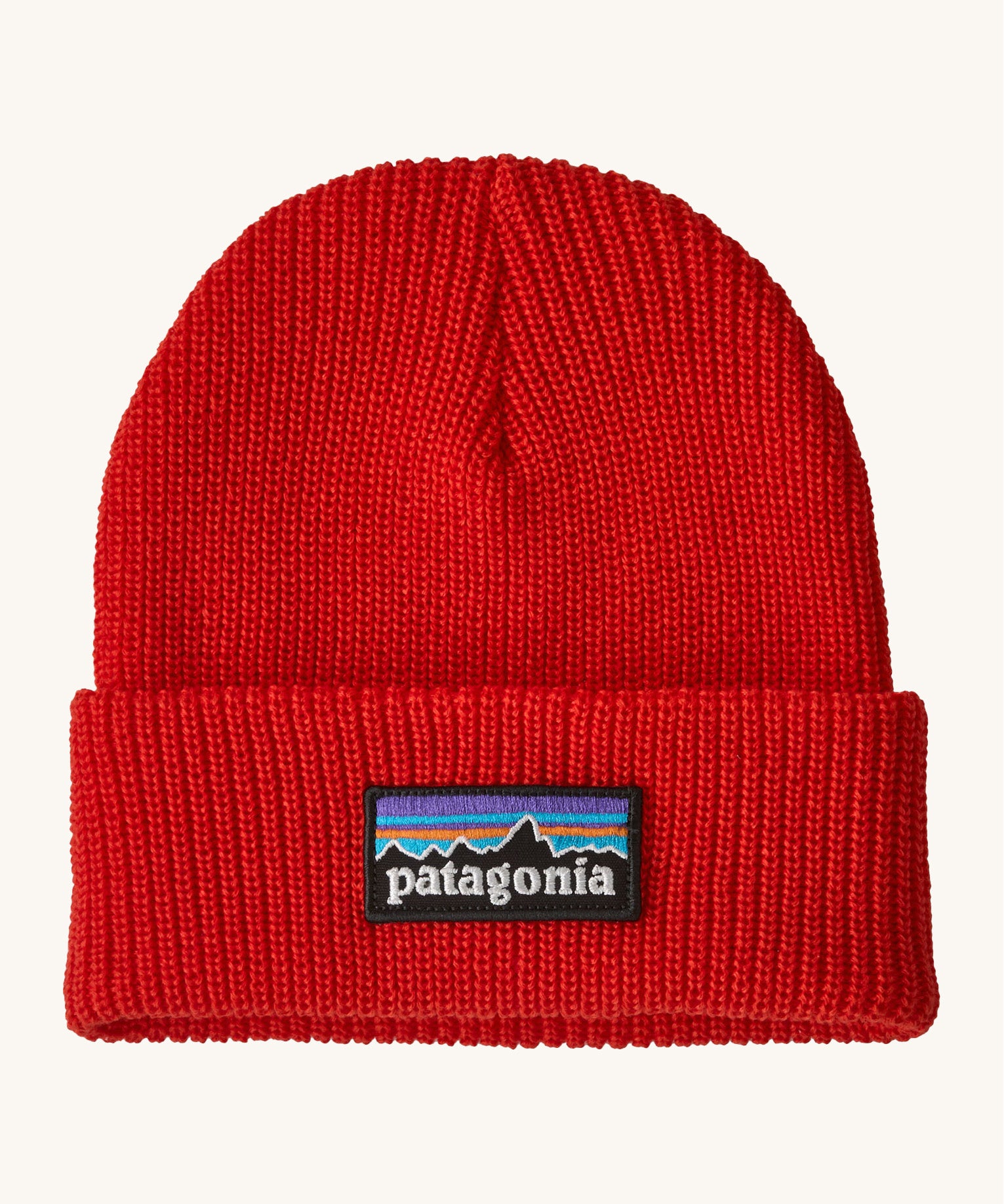 Patagonia kids beanie. A ribbed style hat in vibrant red with the logo patch stitched on the turned up brim.