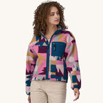 A woman models the front of the Patagonia Women's Synchilla Fleece Jacket - Frontera / Marble Pink.