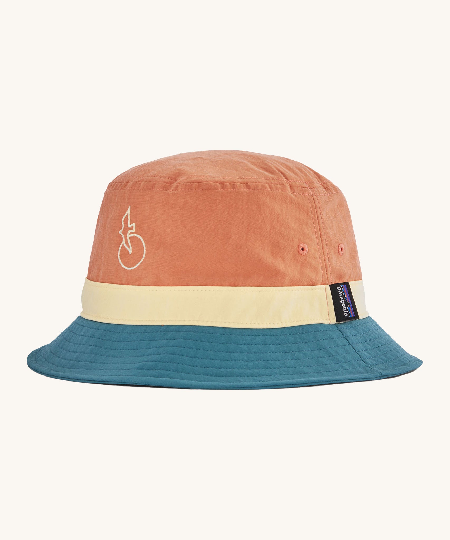 Patagonia wavefarer bucket hat in  blue yellow and orange block colour on a cream background.