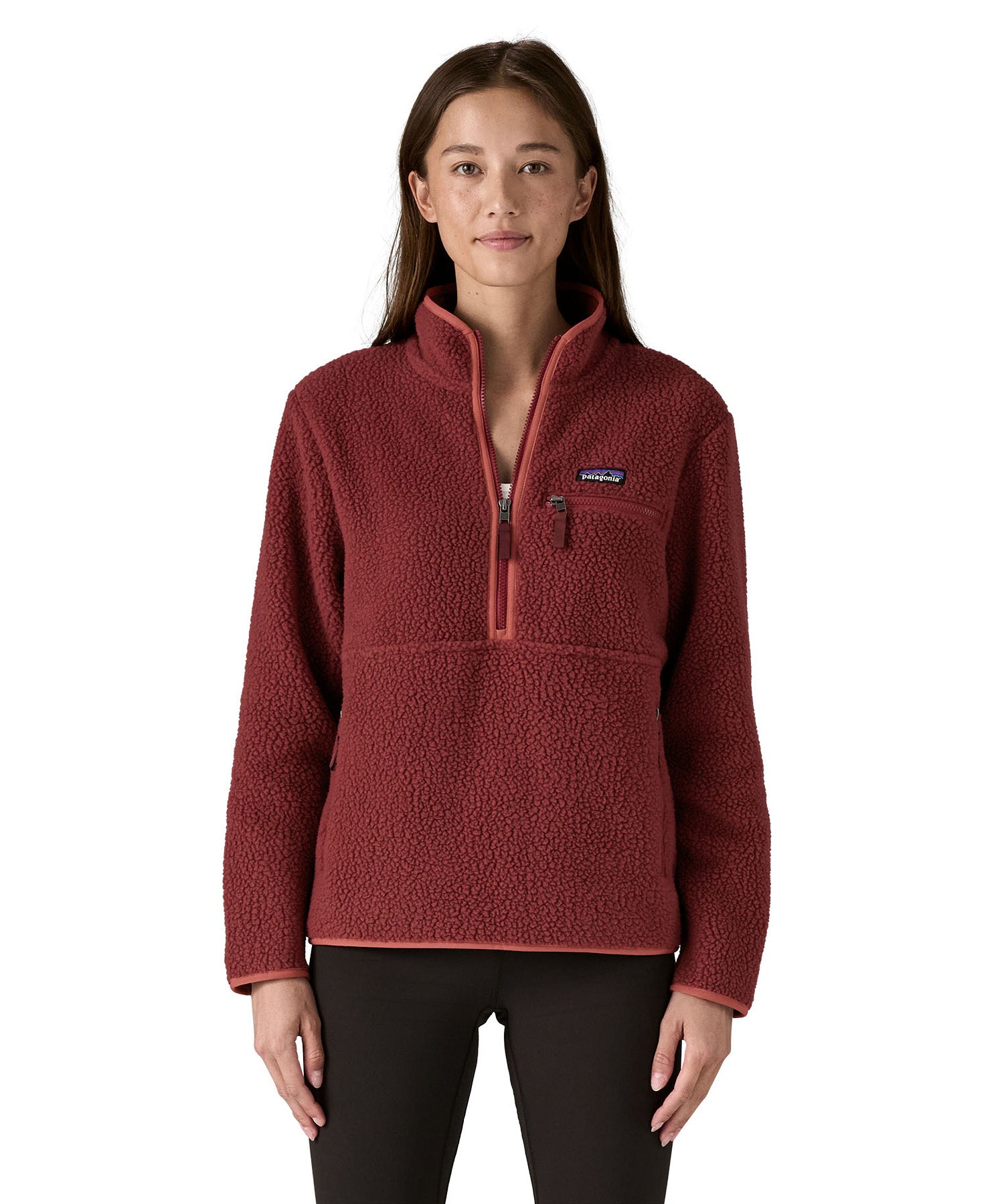 A woman wearing the Patagonia sequoia red marsupial retro fleece showing front trim and zip detail